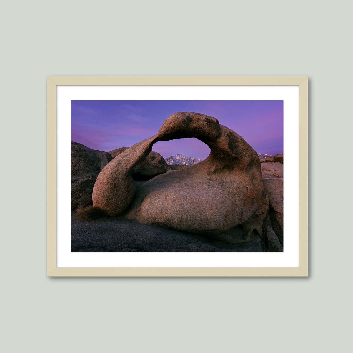 Earth's Embrace, Mobius Arch framing the Sierra Nevada under a violet sky before sunrise in the Alabama Hills, California, in a maple frame with a white mat