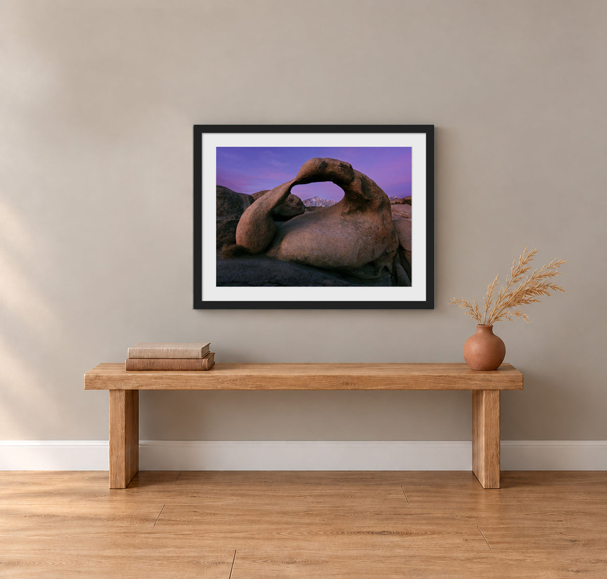 Earth's Embrace, Mobius Arch framing the Sierra Nevada under a violet sky before sunrise in the Alabama Hills, California, in a black frame shown in a home setting