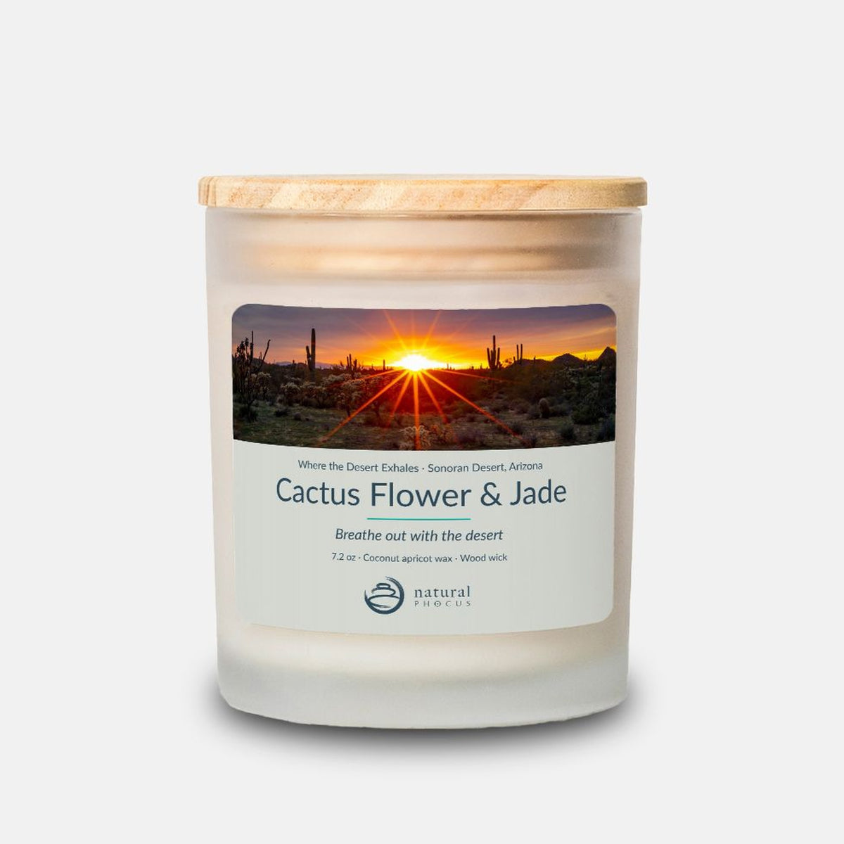 Where the Desert Exhales Candle in Cactus Flower and Jade, a frosted glass candle with a maple wood lid, labeled with a photograph of a sunburst over saguaros and cholla in the Sonoran Desert, Arizona