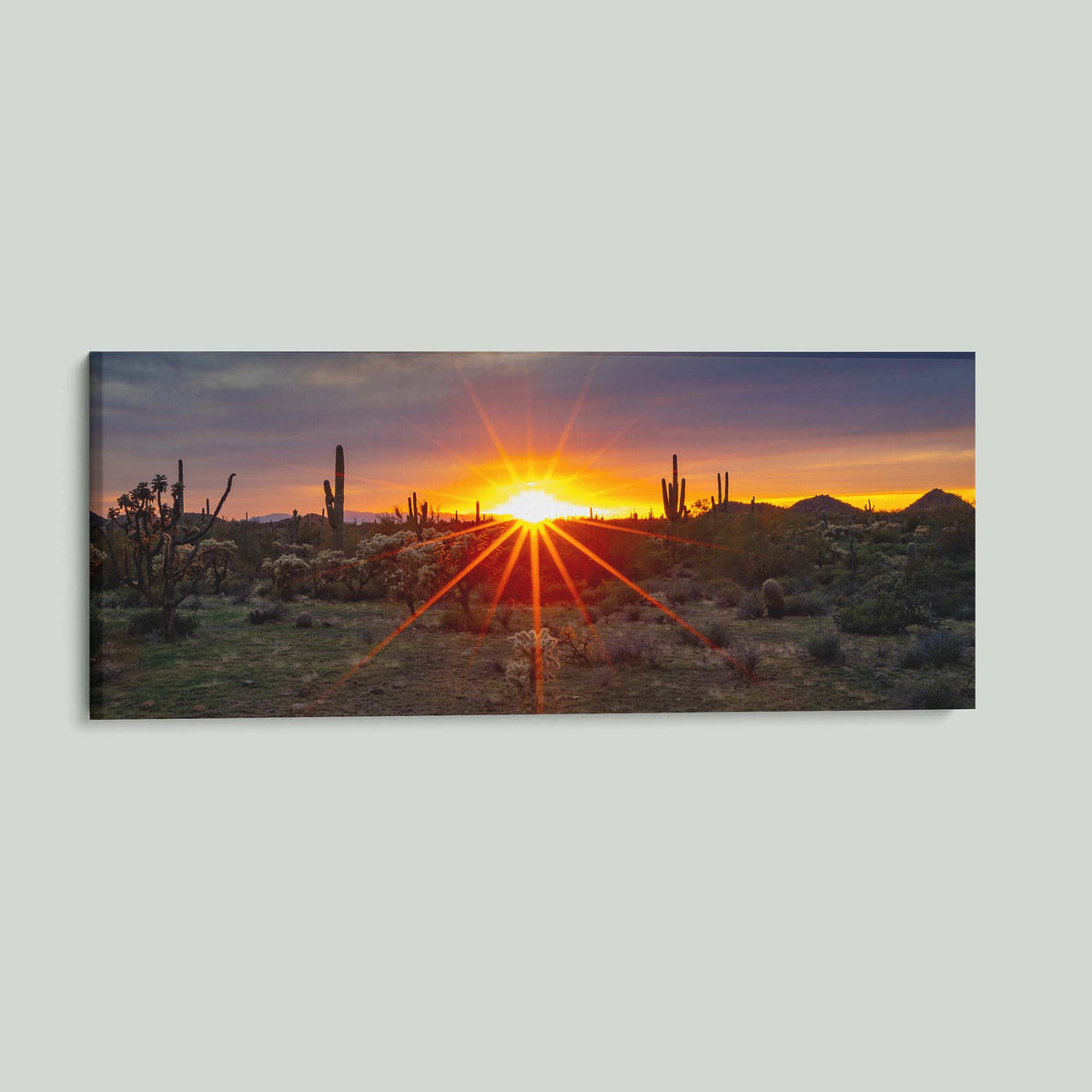 Where the Desert Exhales, a sunset sunburst over saguaro and cholla cacti in the Sonoran Desert of Arizona, as a stretched canvas shown at an angle