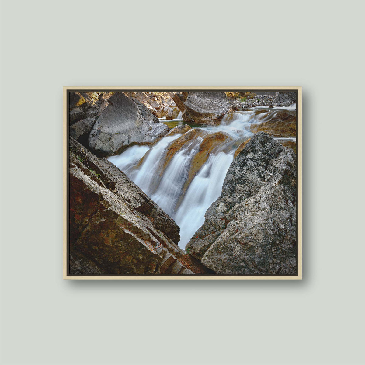 Water Finds a Way, a waterfall flowing between lichen-covered boulders at Hummingbird Falls, Alberta, Canada, as a canvas in a maple floating frame