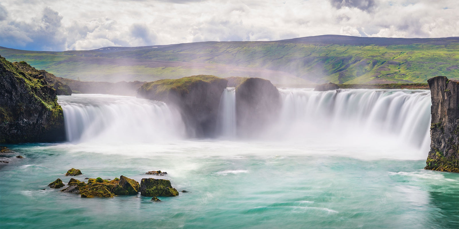 Goðafoss waterfall pouring over a wide curve of cliffs in northern Iceland