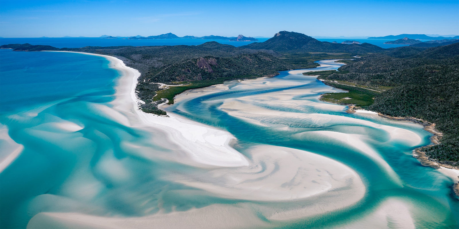 Swirling white sand and clear turquoise water at Whitsunday Island, Australia