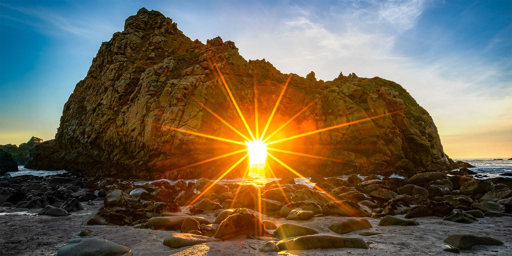 Sunset light streaming through Keyhole Arch at Pfeiffer Beach, Big Sur, California, photographed by Steve Austin