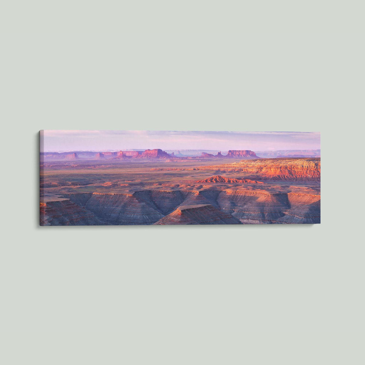 Muley Point, sunrise over the San Juan River canyons with Monument Valley in the distance, from Muley Point in Utah, as a stretched canvas shown at an angle