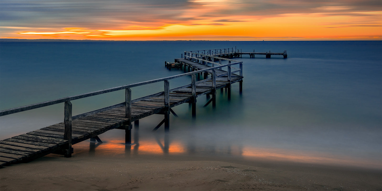 Calm evening water and a jetty at Shelley Beach, Portsea, Victoria, Australia