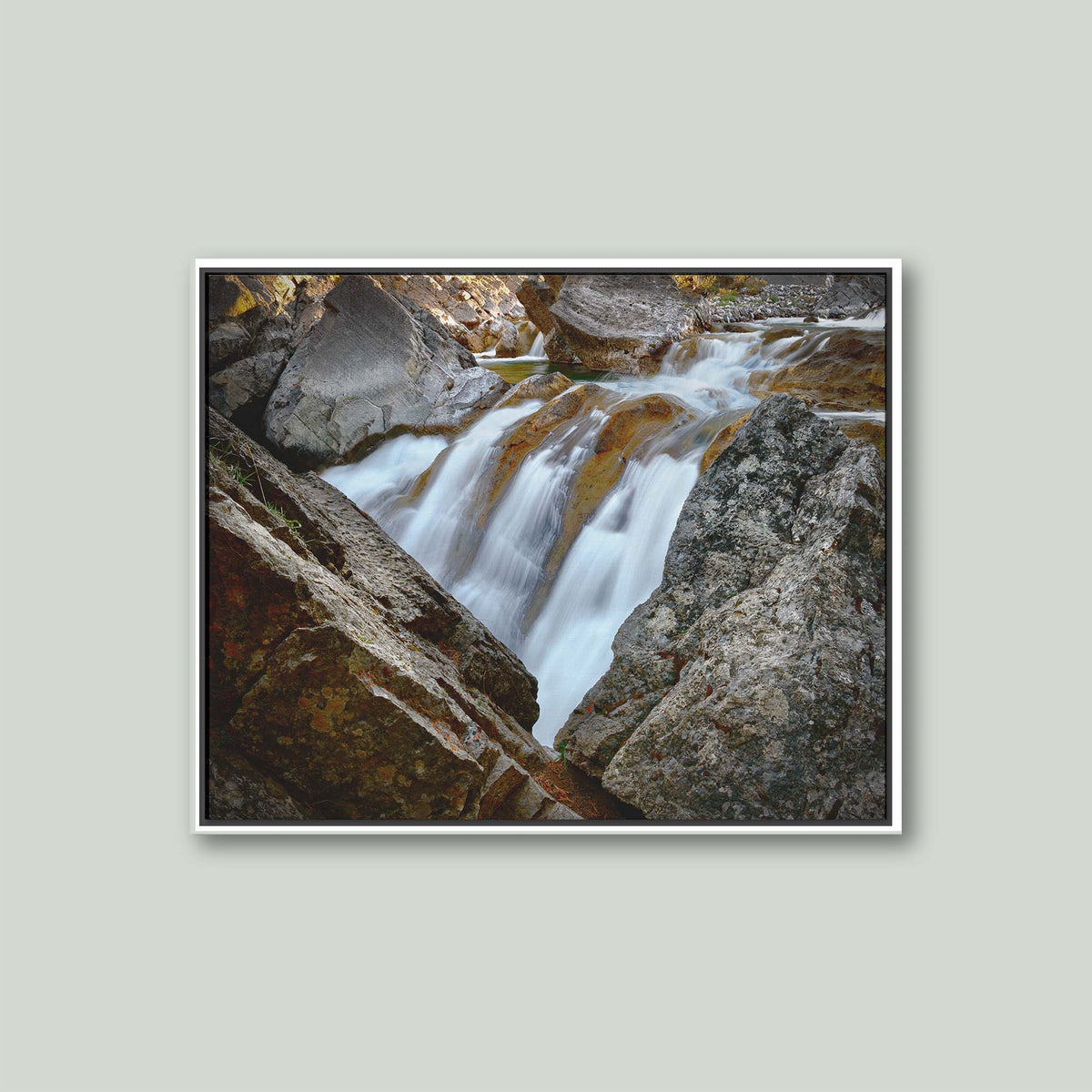 Water Finds a Way, a waterfall flowing between lichen-covered boulders at Hummingbird Falls, Alberta, Canada, as a canvas in a white floating frame