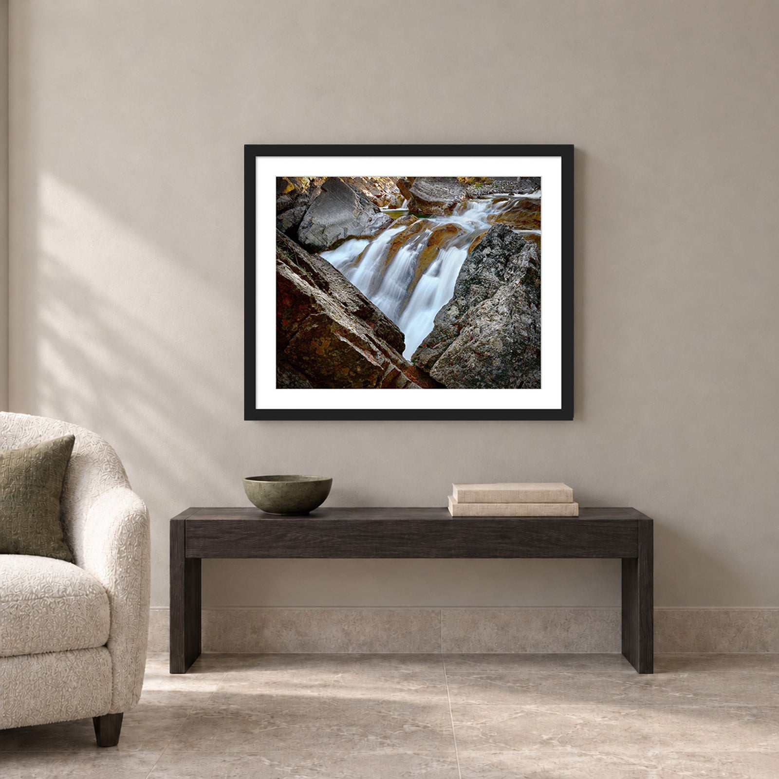 Water Finds a Way, a waterfall flowing between lichen-covered boulders at Hummingbird Falls, Alberta, Canada, in a black frame shown in a home setting